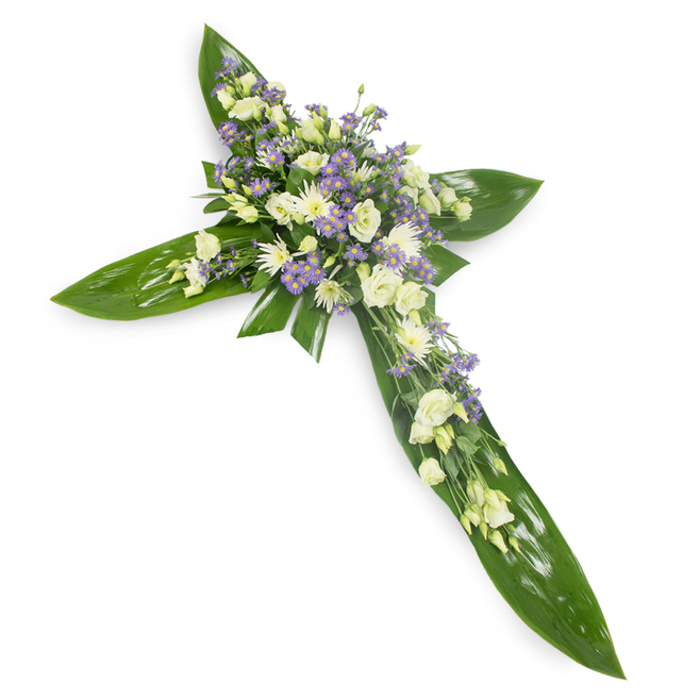 Against a plain white background, this floral cross is a study in calmness and craft: the cross itself is sculpted from large, glossy green leaves-think Ti or similar tropical foliage-laid with precision so their smooth veins and gentle sheen form strong horizontal and vertical lines. At the junction and along each arm rests a generous arrangement of soft, creamy-white lisianthus, their petals folding inward in layered ruffles that suggest both tenderness and dignity. Nestled between the lisianthus are small, rounded white blooms-miniature chrysanthemums or spray roses-that add bright points of texture and increase the visual warmth of the centre. Interspersed throughout are sprays of pale lavender or light purple accent flowers, likely limonium or petite asters, whose tiny star-shaped blossoms create a delicate dusting of colour and subtle depth. Slender strands of fine green filler foliage breathe between the clusters, giving the composition an organic rhythm and softening the transition from leaf to bloom. The lighting is even and soft, the arrangement's surfaces reflecting a gentle glow that enhances the ivory and lavender tones without drama. The scent this picture evokes is muted and fresh-green leaf, faint floral sweetness-and the overall mood is one of reverent calm, appropriate for a funeral chapel, memorial service, or graveside gathering near Leicester Square or the Chinatown Gate. Crafted with careful technique and quiet intention, this cross reads as a respectful, comforting statement of condolence-an emblem of remembrance shaped with local sensitivity and florist's care.