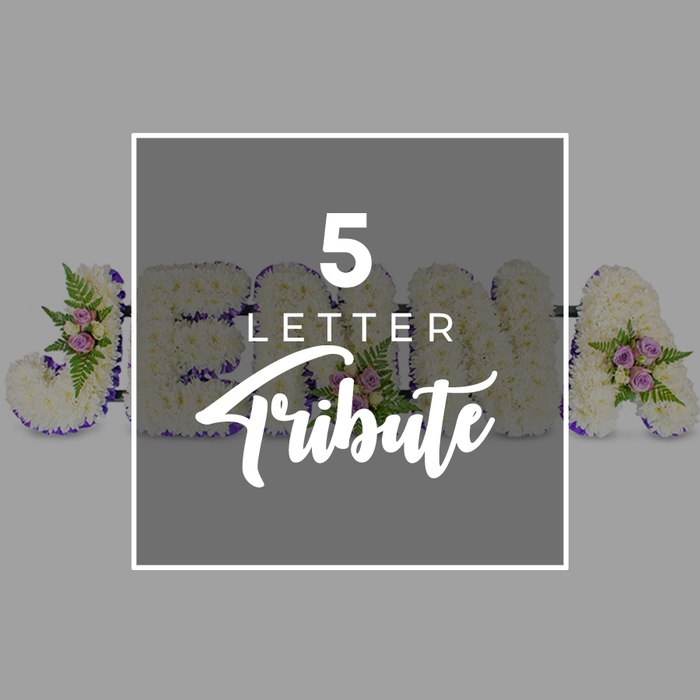 A personalised five-letter funeral tribute is displayed here in meticulous detail, echoing the kind of carefully considered farewells often arranged for families in and around London's Chinatown. Set against a soft, neutral light grey background, the arrangement features large, block-style letters lying side by side. These letters are completely covered with densely massed white chrysanthemums or similar small-headed blooms, forming a thick, textured surface that looks both plush and serene. The brightness of the white is held in and emphasised by a narrow edge of deep purple satin ribbon that neatly outlines each letter, the ribbon's subtle sheen catching the light and adding a quiet sense of richness and poise. To soften the structure and introduce gentle colour, the florist has integrated small floral groupings at strategic points along the tribute. These clusters contain delicate spray roses in shades of pale pink and muted mauve, accompanied by arching green fern fronds and scattered leaves, which together bring a natural, garden-like feel and hint at tenderness and remembrance. Over the centre of the arrangement, partially obscuring some of the letters, is a square overlay in a slightly darker tone of grey, finished with a slim white border. On this square, crisp white text reads 5 LETTER in uppercase, stacked above the more flowing script of the word Tribute, clearly signposting that the design represents a five-letter name or word tribute. Portions of individual floral letters remain visible around the overlay, suggesting forms like J, O, H, N and A. The overall image communicates a sense of calm, crafted beauty and personal care, suitable for honouring someone special with a name tribute delivered to services near Chinatown and the wider West End.