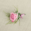 On a backdrop of softly woven beige fabric, reminiscent of natural linen laid out on a table in a Chinatown studio, a single pink rose boutonniere becomes the quiet centre of attention. The rose lies at a gentle diagonal, its bloom compact and purposeful, with outer petals shaded in vivid magenta-pink and inner layers evolving into a gentle pastel blush. Each petal appears velvety and freshly opened, as if cut just moments ago from a morning delivery. Around the rose, delicate sprays of white gypsophila punctuate the design with tiny, cloud-like blooms that lend lightness and a sense of celebration, much like the flutter of confetti drifting down during a wedding near Wardour Street. Slender, grass-like strands of greenery arc gracefully from behind the flower, adding movement and a whisper of wildness that contrasts with the otherwise tailored composition. At the base, a single broad leaf in deep emerald is carefully curled to form a smooth, protective collar, its surface carrying a few bright drops of water that reflect the light and emphasise the freshness of the piece. The stems are tightly bound with a smooth, pale pink satin ribbon, wrapped in precise, even bands, and finished with a narrow darker magenta bow at the base, echoing the deeper shades of the rose petals. The overall impression is one of polished elegance with a romantic softness, ideal for a groom or wedding guest celebrating in and around London's Chinatown, where modern city style and cultural tradition meet with quiet grace.